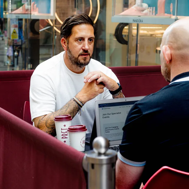Shaun Greenaway talking with a client over coffee